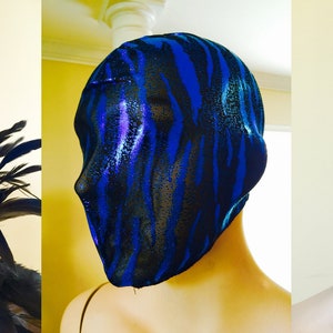 May include: A blue and black patterned mesh face mask. The mask is made of a stretchy material and covers the entire head. The pattern is a zebra print.