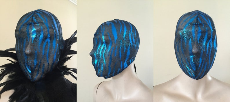 May include: A black and blue face mask with a zebra print pattern. The mask is made of a stretchy material and has a tie at the back.