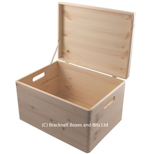 May include: A natural wood storage box with a hinged lid and two side handles. The lid is open and the box is empty. (C) Bracknell Boxes and Bits Ltd