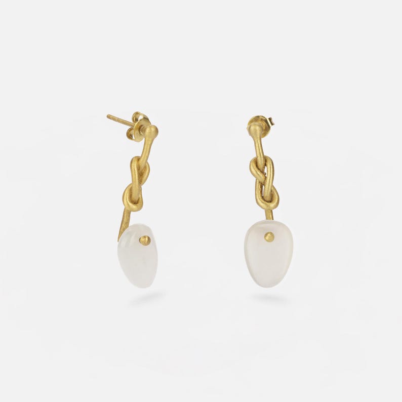 Handmade long brass 18k gold plated knot earrings with Moonstone gem. Boho-chic artisanal jewelry, perfect for elegant and natural looks.