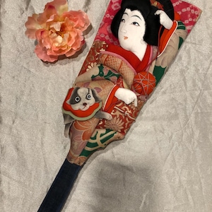 Vintage Japanese wooden hagoita paddle hand decorated geisha playing with dog high relief art handmade, bell inside rings geisha oshi-e art