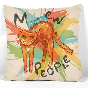 May include: A colorful pillow with a cartoon orange cat and the text "Meow People" in black. The background is a mix of yellow, orange, green, and blue paint splatters.