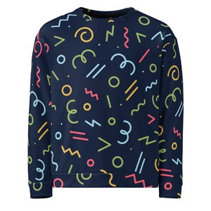 May include: A navy blue sweatshirt with a colorful geometric pattern. The pattern includes circles, zigzags, squiggles, and lines in yellow, pink, green, and blue.
