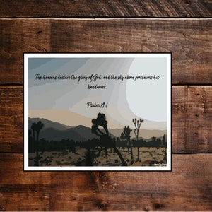 May include: A digital art print featuring a desert landscape with Joshua trees and a quote from Psalm 19:1, "The heavens declare the glory of God, and the sky above proclaims his handiwork."