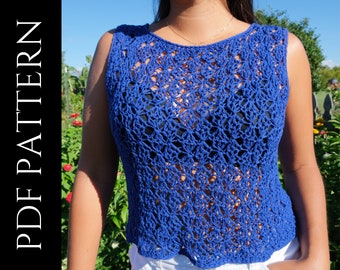 May include: A sleeveless, cobalt blue crochet top with a delicate openwork design. The top has a scalloped hemline and is worn with white shorts. The text "PDF PATTERN" is on the left side of the image.