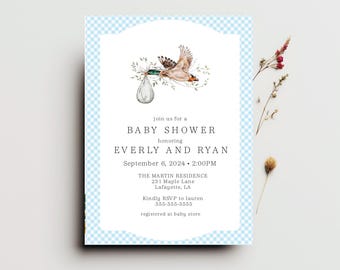 May include: A blue and white gingham patterned baby shower invitation with a watercolor illustration of a bird carrying a baby's pacifier. The text reads "Join us for a Baby Shower honoring Everly and Ryan September 6, 2024 2:00PM The Martin Residence 231 Maple Lane Lafayette, LA Kindly RSVP to lauren 555-555-5555 registered at baby store"