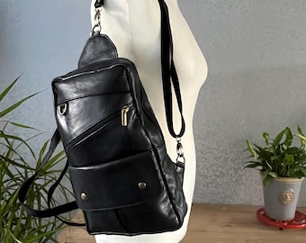 Mochila bandolera de piel hecha a mano en color negro.