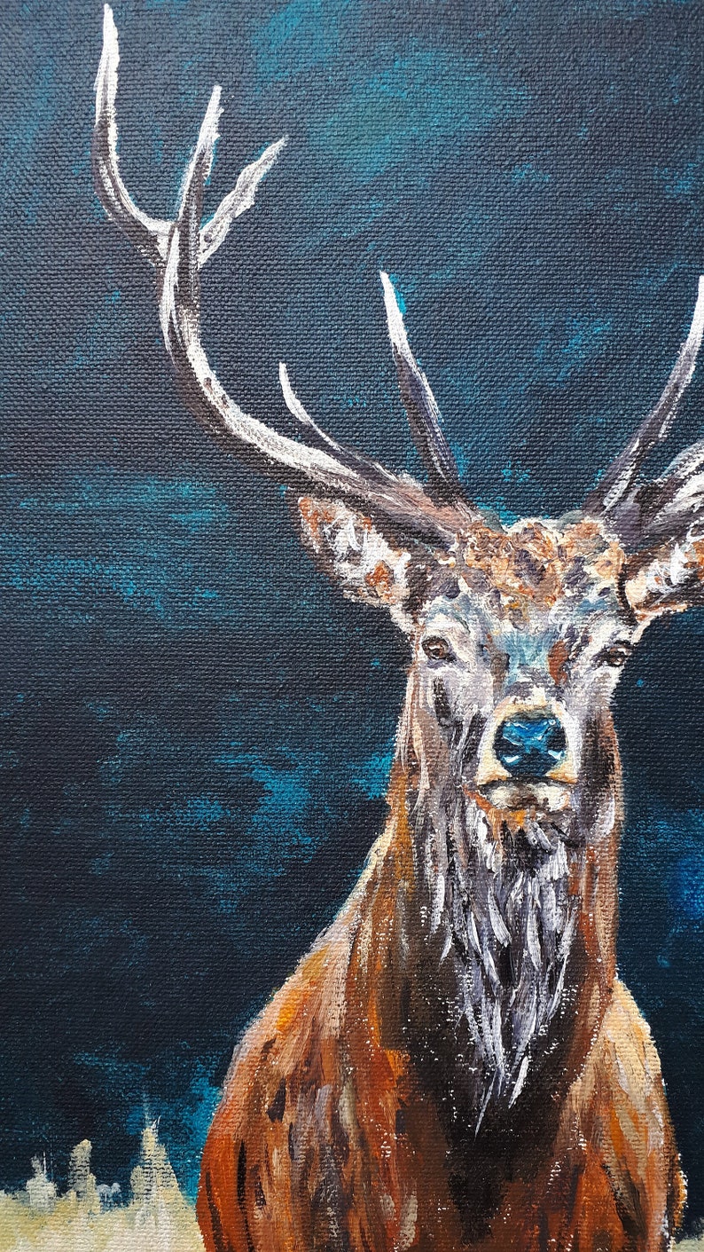 May include: A detailed painting of a stag with large antlers against a dark blue background. The stag has brown fur with white accents on its antlers and chest. The artwork is a close-up portrait.