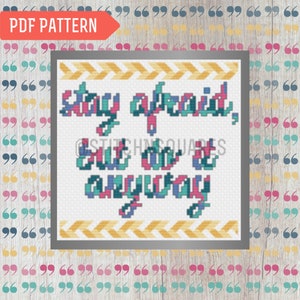 May include: Cross stitch pattern with a white background and colorful text that reads "stay afraid, but do it anyway". The text is surrounded by a yellow chevron border.