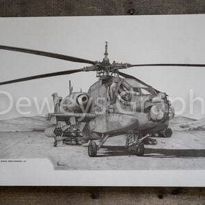 May include: A black and white pencil drawing of a military helicopter, the AH-64 Apache, with a desert background. The helicopter is armed with rockets and missiles. The drawing is signed "DEWEY LANDGREN '09".