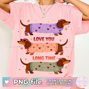 Puede incluir: Camiseta rosa con tres perros salchicha con suéteres con patrones de corazones. El texto "LOVE YOU LONG TIME" está encima de los perros. La parte inferior de la imagen tiene el texto "PNG file TRANSPARENT BACKGROUND".