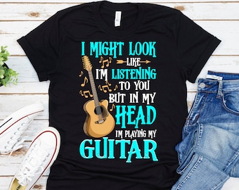 May include: Black t-shirt with a graphic of an acoustic guitar and the text "I might look like I'm listening to you but in my head I'm playing my guitar".