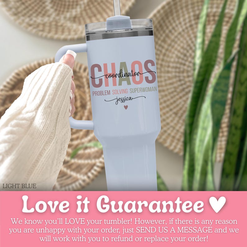 May include: Light blue tumbler with a handle, featuring the words "CHAOS coordinator PROBLEM SOLVING SUPERWOMAN jessica" in a mix of fonts and colors. Includes a straw and a lid. The tumbler is held by a person wearing a white sweater.
