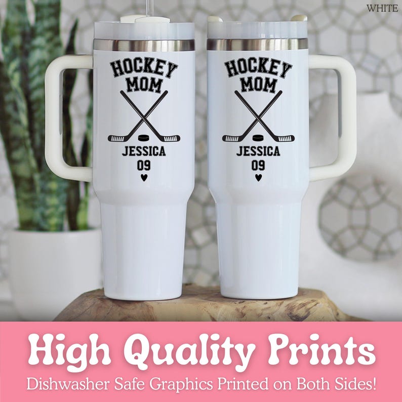 May include: Two white stainless steel tumblers with handles and clear lids. Each features black text reading HOCKEY MOM, JESSICA, and 09, with a graphic of two crossed hockey sticks, a puck, and a small heart printed on the front surface.