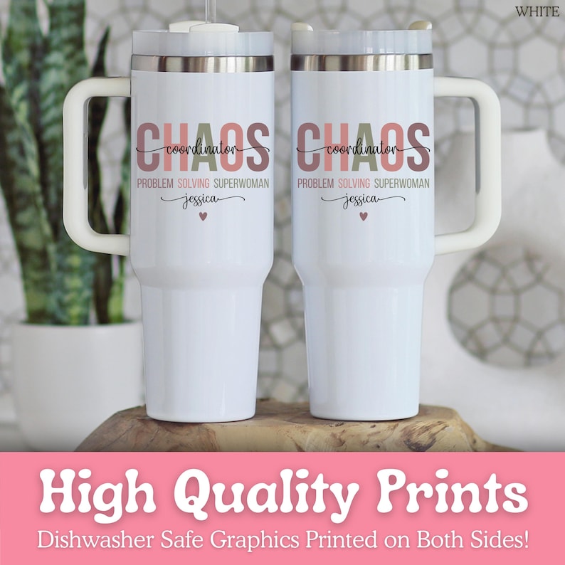 May include: Two white travel mugs with handles, each featuring the text "CHAOS coordinator" in a mix of colors. Below, it reads "PROBLEM SOLVING SUPERWOMAN" and "jessica" with a heart. The mugs are on a wooden surface.