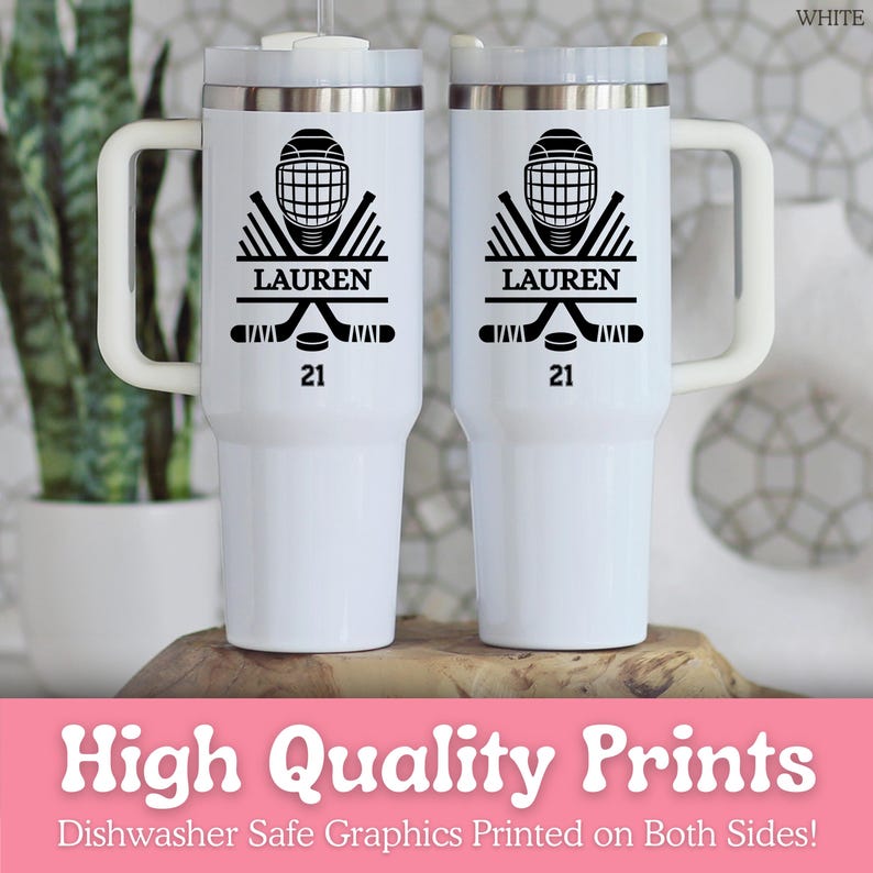 May include: Two white insulated travel mugs with black hockey graphics. Each mug displays a hockey helmet, crossed sticks, a puck, the name "LAUREN", and the number "21". The mugs have white handles and lids. The text "High Quality Prints" is also visible.