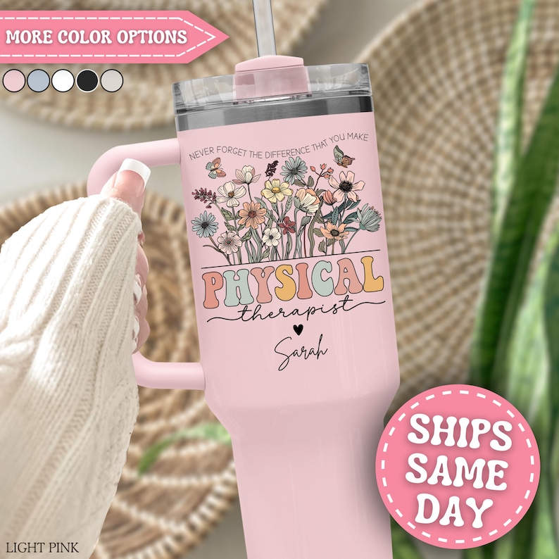 May include: A light pink tumbler with a handle, straw, and a floral design. The tumbler has the words "PHYSICAL therapist" and "Sarah" printed on it. The text "NEVER FORGET THE DIFFERENCE THAT YOU MAKE" is also printed on the tumbler.