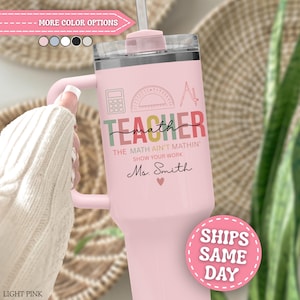 May include: A light pink stainless steel tumbler with a handle and a clear lid. The design features a calculator, protractor, and compass icon above the text TEACHER, math, THE MATH AIN'T MATHIN', SHOW YOUR WORK, and Ms. Smith with a heart.