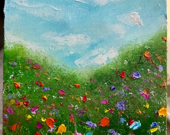 May include: A painting of a field of wildflowers with a blue sky and white clouds in the background. The flowers are painted in a variety of colors, including red, orange, yellow, pink, purple, and blue.
