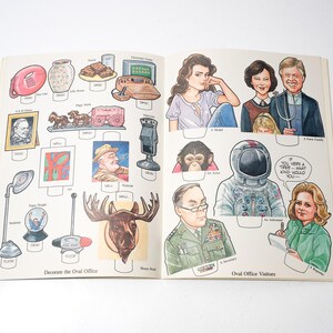 May include: Open book with illustrations of historical figures, objects, and people. The left page features items like a lamp, a moose head, and a portrait. The right page shows portraits of people, including an astronaut and a family.