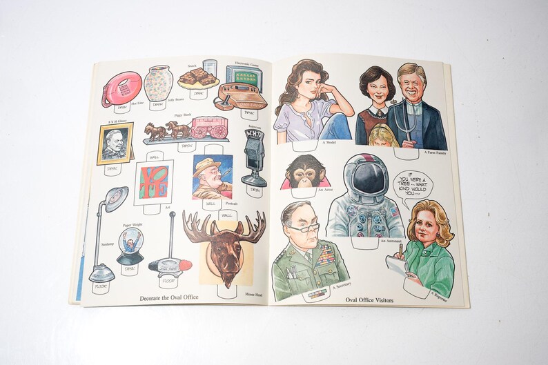 May include: Open book with illustrations of historical figures, objects, and people. The left page features items like a lamp, a moose head, and a portrait. The right page shows portraits of people, including an astronaut and a family.