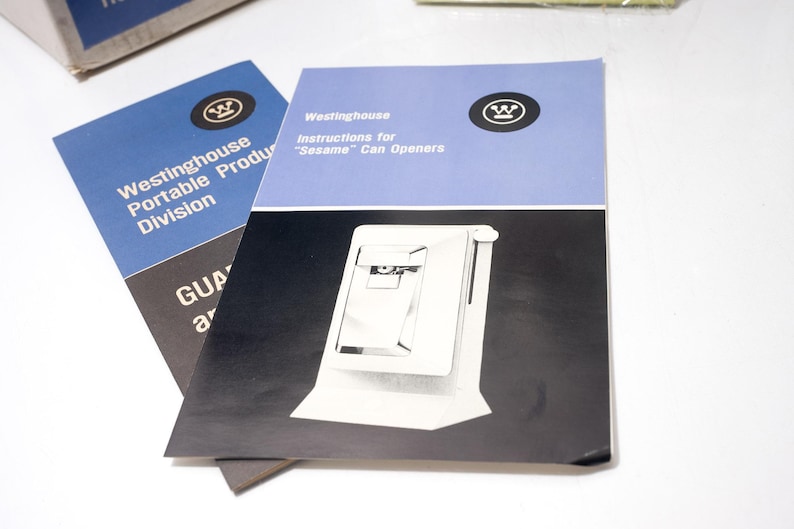 May include: Two vintage Westinghouse manuals. One is blue and black with the text "Westinghouse Portable Product Division". The other is blue and white with the text "Instructions for 'Sesame' Can Openers". Both feature the Westinghouse logo.