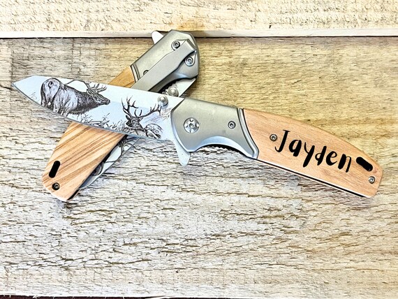 A wood-handled, stainless-steel pocket knife with custom engraving — tactile, practical, and genuinely giftable in a way a cutting board never is.
