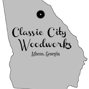 May include: A gray outline of the state of Georgia with the text "Classic City Woodworks" and "Athens, Georgia" below. A black saw blade icon is in the upper center of the image.
