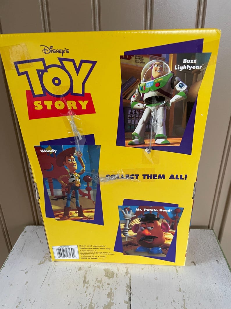 May include: Yellow Toy Story box featuring Woody, Buzz Lightyear, and Mr. Potato Head. The box has the Disney's Toy Story logo and the text "COLLECT THEM ALL!" The box is on a white surface.