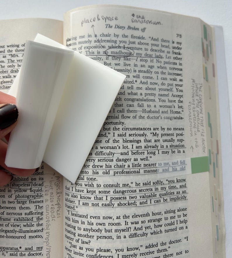 May include: A close-up of a book page with a white eraser on top of the text. The text is about a doctor and a patient. The text reads "This is no madhouse, my dear lady. Let other" and "But we live in an age when nervous insanity is steadily on the increase;"