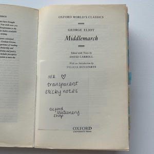 May include: A close-up of a book cover for the Oxford World's Classics edition of "Middlemarch" by George Eliot. The cover is cream-colored with black text. The book is edited with notes by David Carroll and has an introduction by Felicia Bonaparte.