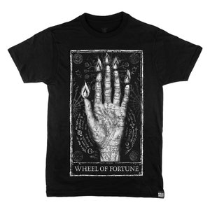 May include: Black t-shirt featuring a white graphic print of a hand with flames and symbols. The text "WHEEL OF FORTUNE" is printed below the graphic.