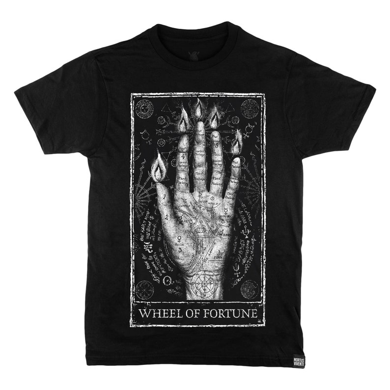 May include: Black t-shirt featuring a white graphic print of a hand with flames and symbols. The text "WHEEL OF FORTUNE" is printed below the graphic.