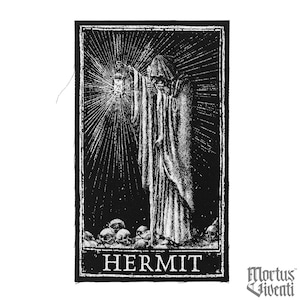 May include: Black and white patch featuring the Hermit tarot card illustration. The design depicts a robed figure holding a lantern, with a radiant light emanating from it. The word "HERMIT" is at the bottom, with skulls below the figure.
