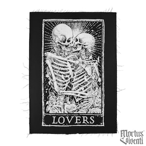 May include: Black and white patch featuring a detailed illustration of two skeletons embracing and kissing. The word "LOVERS" is printed in white at the bottom. The patch has a black border with frayed edges.