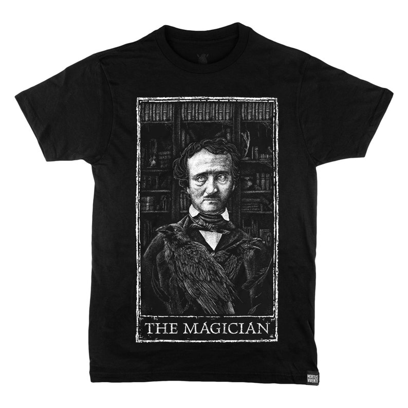 May include: Black t-shirt featuring a white graphic of Edgar Allan Poe with a raven on his shoulder. The graphic is framed in a white rectangle with the text "THE MAGICIAN" at the bottom.