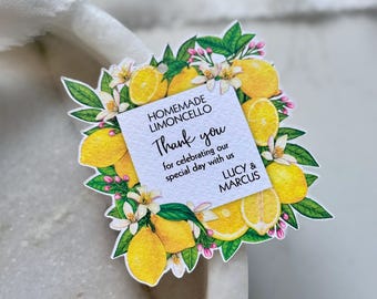 May include: A decorative tag with a lemon and floral design. The tag reads "Homemade Limoncello" and "Thank you for celebrating our special day with us Lucy & Marcus."