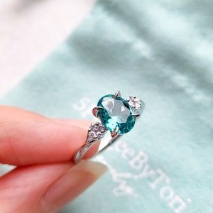 SHINee 5.25 Ring With a 6*8mm Oval Nano Tourmaline Paraiba & CZ Flowers/ Rhodium plated sterling silver