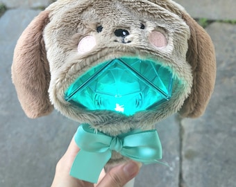 May include: A light blue and brown plush light-up toy shaped like a dog with a turquoise gem in the center. The toy has a turquoise bow and the text "5HINeeByTori" is visible at the bottom of the image.