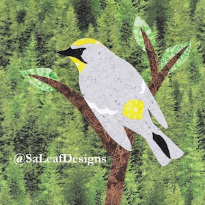 May include: A gray bird with a yellow head and a yellow spot on its tail sits on a brown branch with green leaves against a green background. The bird is perched on a branch with green leaves. The background is a green forest.