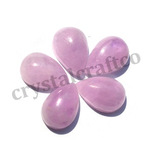 May include: Five light pink teardrop-shaped gemstone cabochons. The cabochons are smooth and polished.