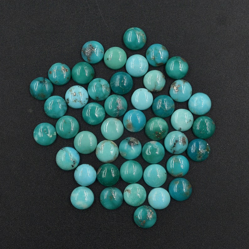 Arizona turquoise cabochons, round 4-20mm blue-green gemstones with natural matrix in a loose lot.
