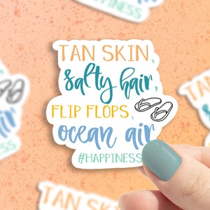 May include: White sticker with blue and yellow text that reads "TAN SKIN, salty hair, FLIP FLOPS, ocean air #HAPPINESS". The sticker has a pair of flip flops drawn on it.