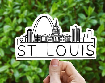 May include: A black and white line drawing of the St. Louis skyline, including the Gateway Arch, the Old Courthouse, and other buildings. The drawing is on a white background and the words "ST. LOUIS" are written below the skyline.