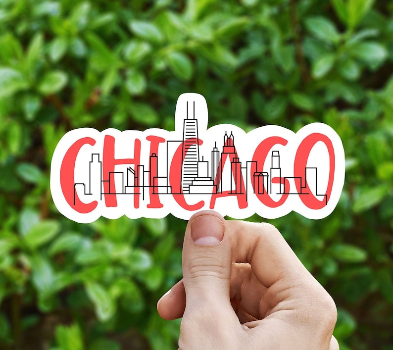 May include: A red and white sticker with a black outline of the Chicago skyline. The sticker says "CHICAGO" in a bold, stylized font.