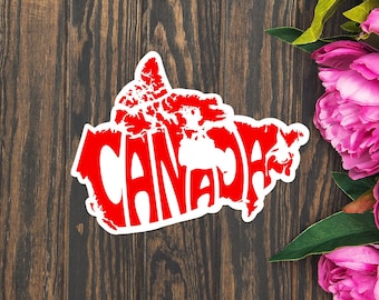 May include: A red and white sticker of the outline of Canada with the word "CANADA" spelled out in red letters inside the outline.