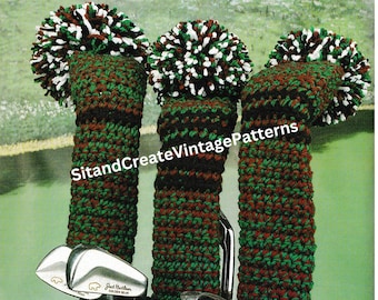 May include: Three crocheted golf club covers with pom-poms in red, white and green. The covers are on golf clubs in a golf bag.
