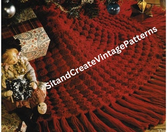May include: A red crocheted Christmas tree skirt with a textured design and fringe. The skirt is decorated with a small doll and presents.