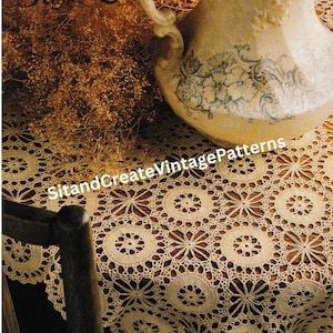 May include: A cream-colored crocheted tablecloth with a floral design, draped over a wooden table. A vintage pitcher with blue floral accents sits on the table. The text "Pattern from the Past" and "SitandCreateVintagePatterns" are visible.