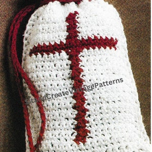 May include: White crocheted drawstring bag with a red cross design. The bag is a DIY project for a cross air freshener or sack.